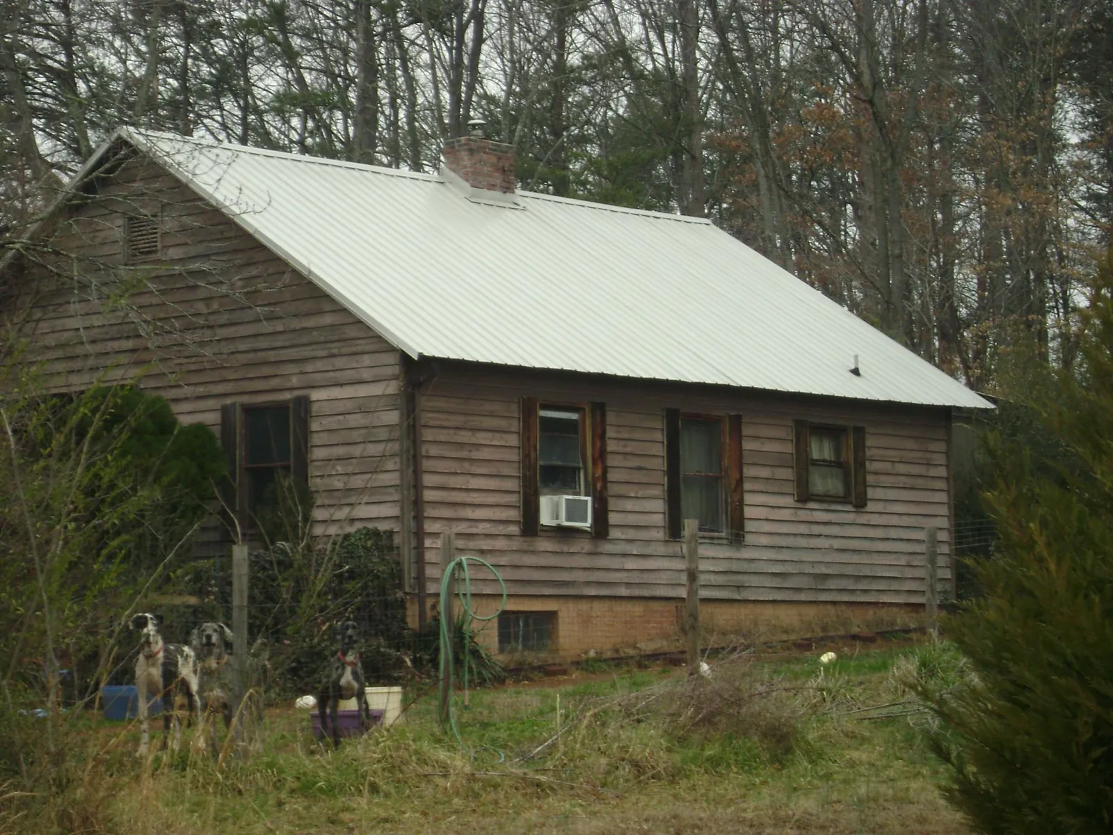 White metal roof on an old wood sided farmhouse, from a Metal Roof Installation job in Rohrersville